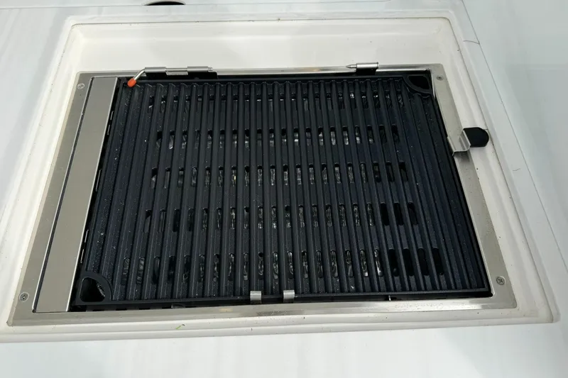 Harley Quinn Yacht Photos Pics Built-in grill on 2023 Regal 36 XO boat, featuring sleek black grates.