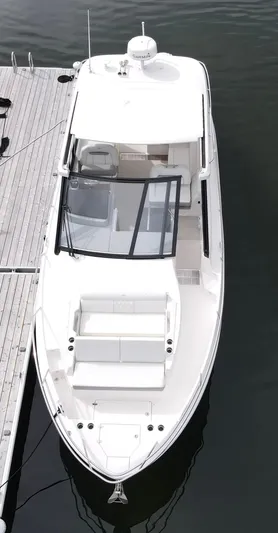 Harley Quinn Yacht Photos Pics 2023 Regal 36 XO boat docked, aerial view, sleek white design.