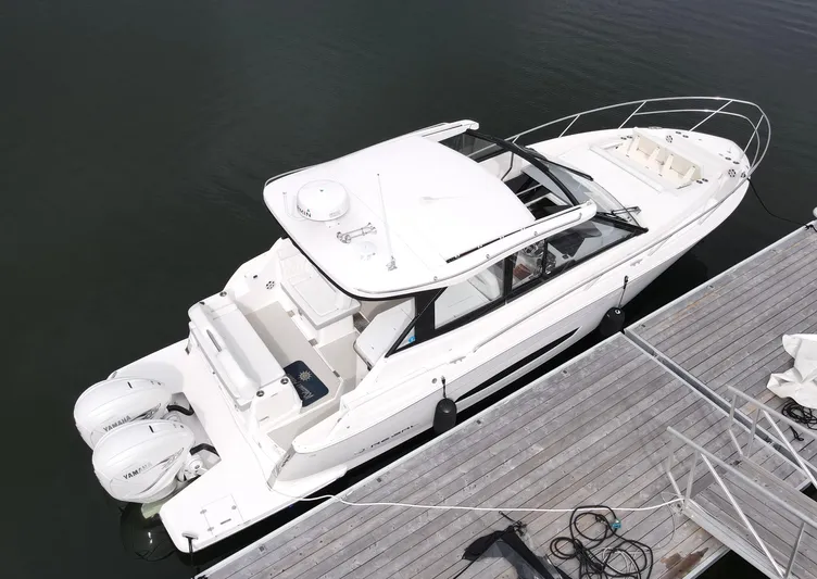 Harley Quinn Yacht Photos Pics 2023 Regal 36 XO boat docked, aerial view, white exterior, twin outboard engines.