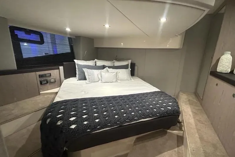  Yacht Photos Pics Luxurious bedroom interior of 2024 Sessa Marine C44 Cruiser yacht, featuring elegant bedding and modern design.