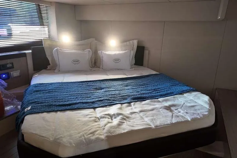 Yacht Photos Pics Luxurious bedroom interior of 2024 Sessa Marine C44 Cruiser with cozy bedding and ambient lighting.
