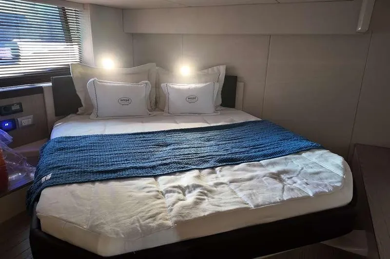  Yacht Photos Pics Luxurious bedroom interior of 2024 Sessa Marine C44 Cruiser with cozy bedding and ambient lighting.