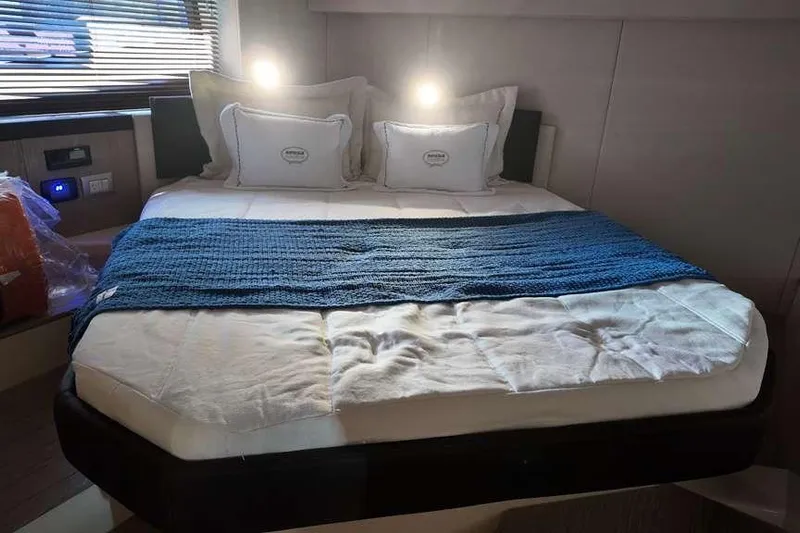  Yacht Photos Pics Luxurious bedroom interior of 2024 Sessa Marine C44 Cruiser with cozy bedding and ambient lighting.