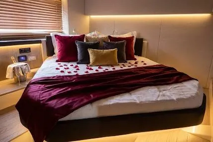  Yacht Photos Pics Luxurious bedroom in 2024 Sessa Marine C44 Cruiser with elegant decor and ambient lighting.