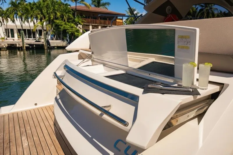  Yacht Photos Pics 2024 Sessa Marine C44 Cruiser with outdoor bar and drinks, docked by waterfront homes.