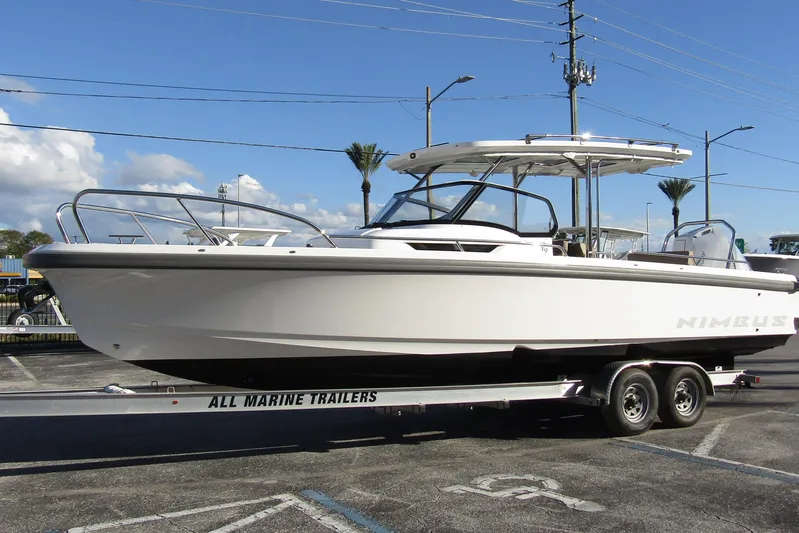  Yacht Photos Pics 2025 Nimbus Tender 9 boat on trailer, parked outdoors under clear sky.