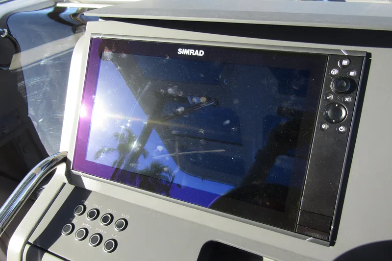  Yacht Photos Pics Simrad display on 2025 Nimbus Tender 9 boat dashboard, reflecting sunlight.