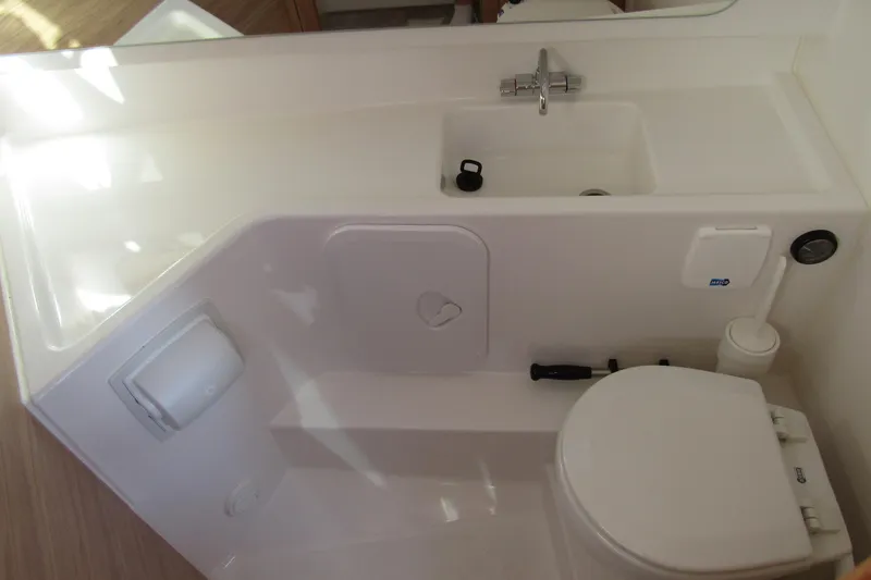  Yacht Photos Pics Compact bathroom in 2025 Nimbus Tender 9 boat with sink and toilet.