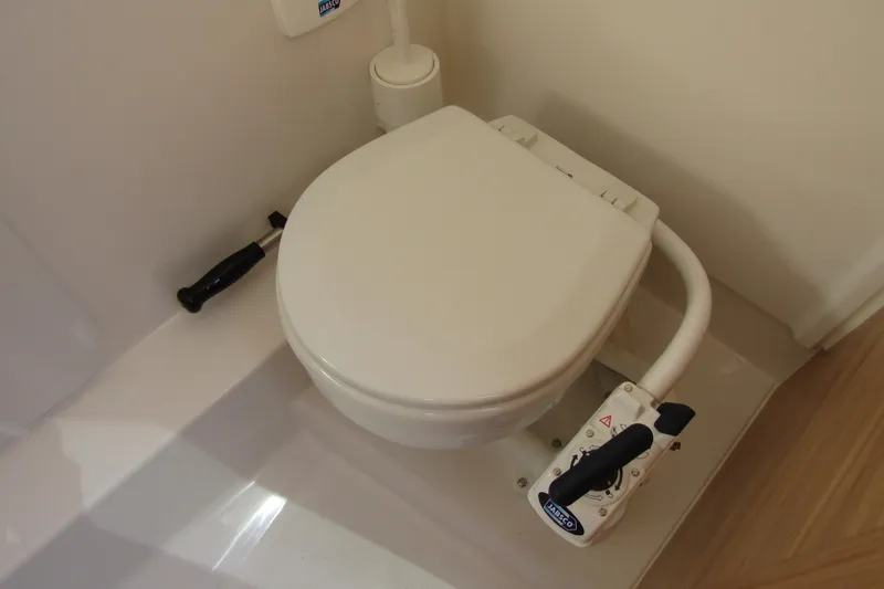  Yacht Photos Pics Boat toilet in 2025 Nimbus Tender 9, featuring manual flush handle and compact design.