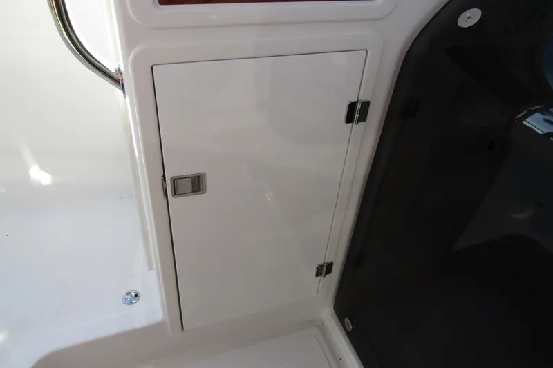  Yacht Photos Pics Storage compartment on 2025 Nimbus Tender 9 boat, featuring sleek white design and secure latch.