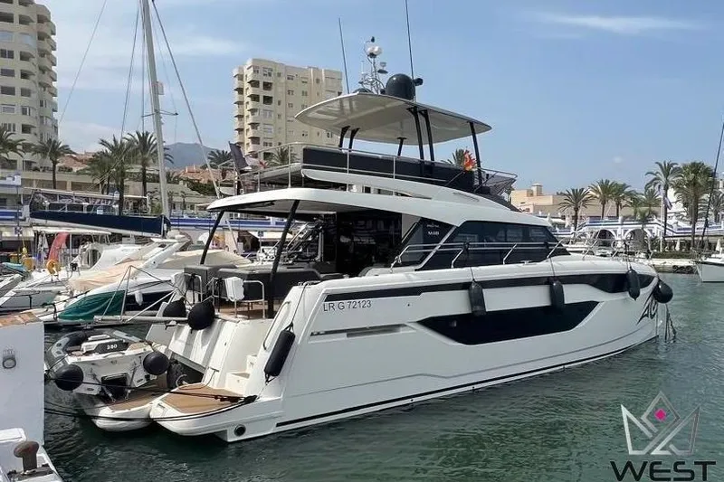 Moana Yacht Photos Pics Luxury 2024 Prestige M48 yacht docked at a marina, showcasing sleek design.