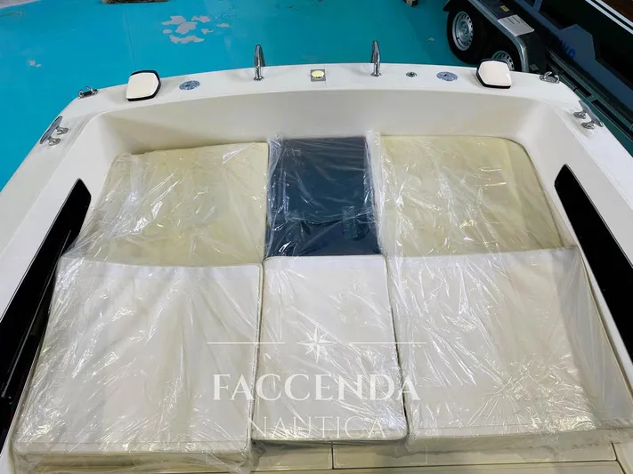  Yacht Photos Pics 1981 Riva SAINT TROPEZ boat interior with cushioned seating, covered in protective plastic.