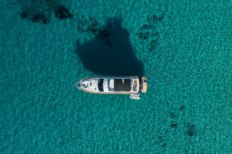 Mr Corn Yacht Photos Pics Aerial view of 2010 Rodman Muse 74 yacht on clear turquoise water.