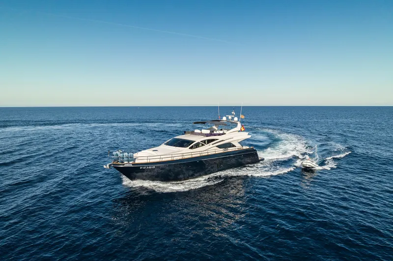 Mr Corn Yacht Photos Pics Luxurious 2010 Rodman Muse 74 yacht cruising on open sea under clear blue sky.