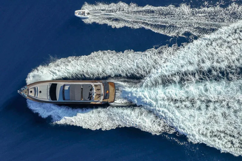 Mr Corn Yacht Photos Pics Aerial view of 2010 Rodman Muse 74 yacht cruising with a smaller boat nearby.