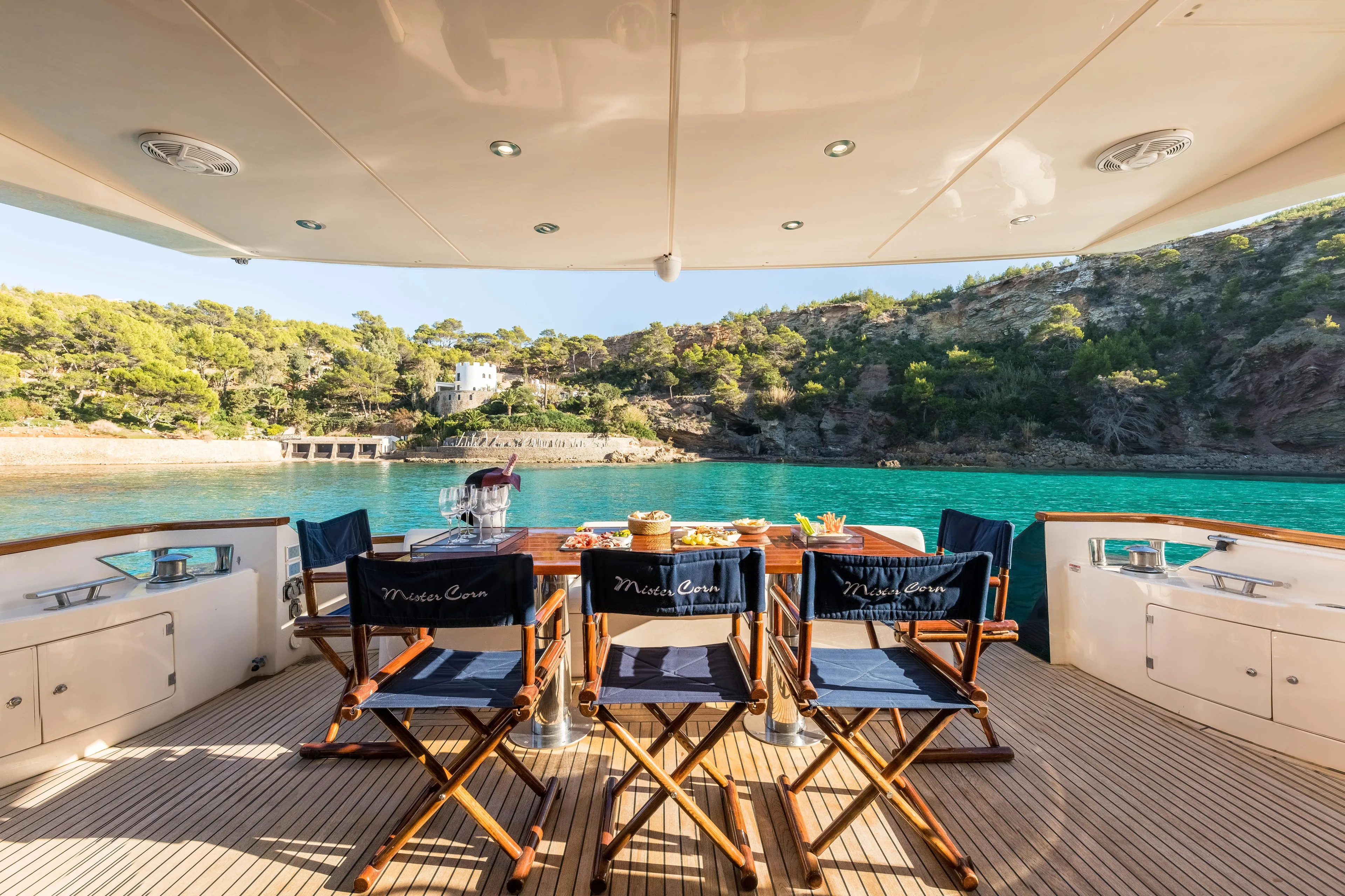 Mr Corn Yacht Photos Pics Luxury dining setup on Rodman Muse 74 yacht, 2010, overlooking serene turquoise waters.