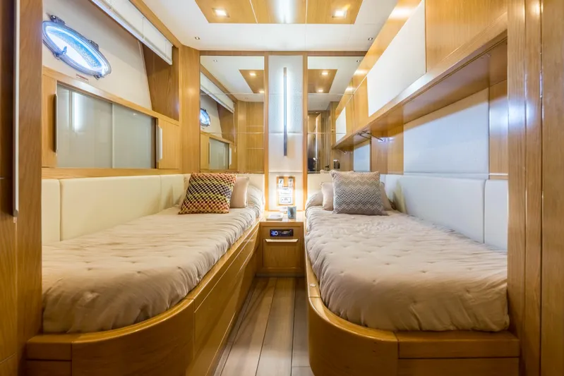 Mr Corn Yacht Photos Pics Luxurious twin cabin interior on 2010 Rodman Muse 74 yacht, featuring elegant wood finishes.