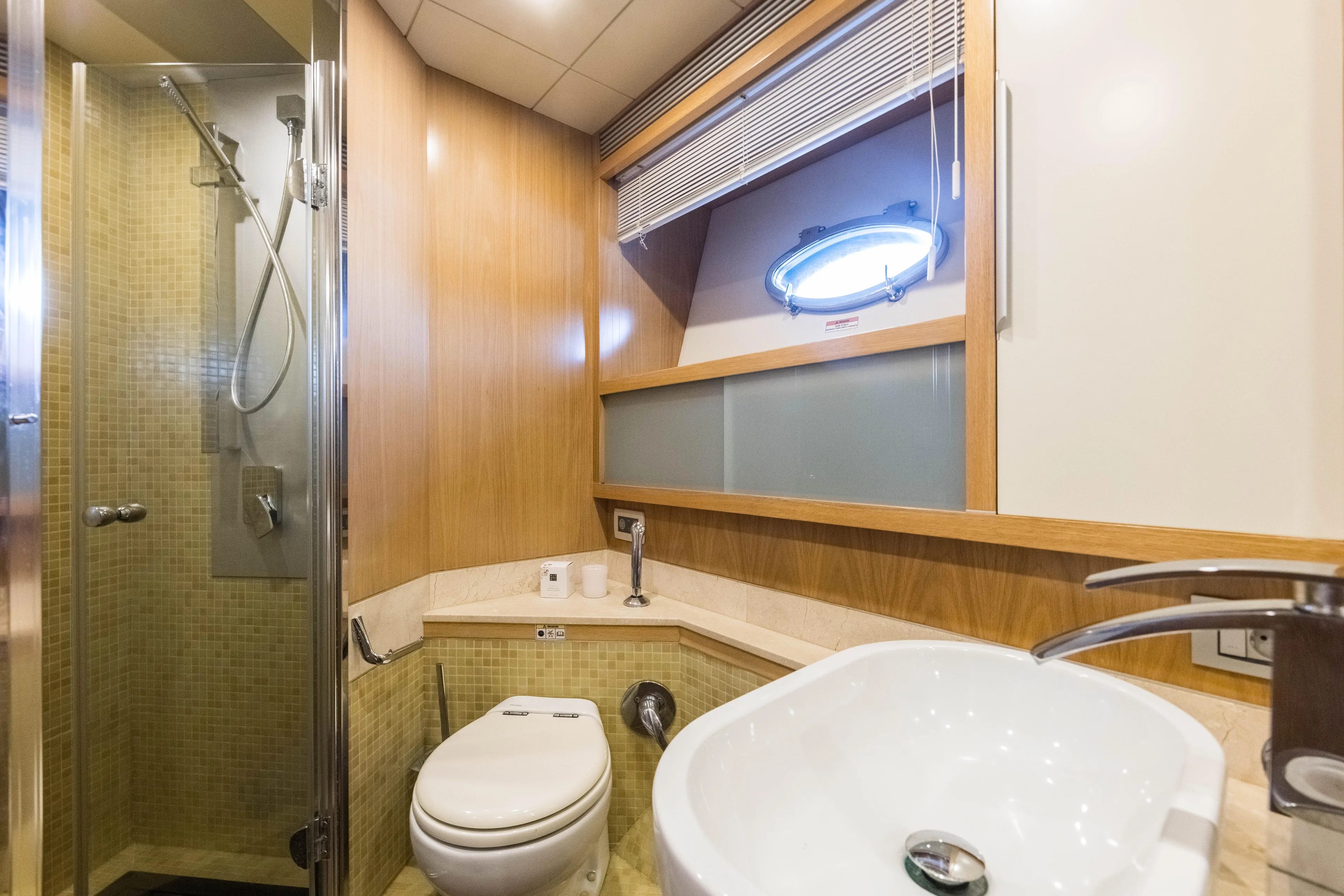 Mr Corn Yacht Photos Pics Luxurious bathroom in 2010 Rodman Muse 74 yacht with shower, sink, and toilet.