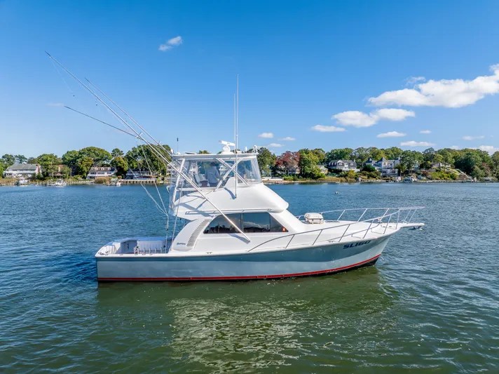 Sligo Yacht Photos Pics 2023 Henriques 42 Convertible yacht on calm water under clear blue sky.