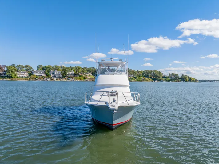 Sligo Yacht Photos Pics 2023 Henriques 42 Convertible yacht on calm water under clear blue sky.