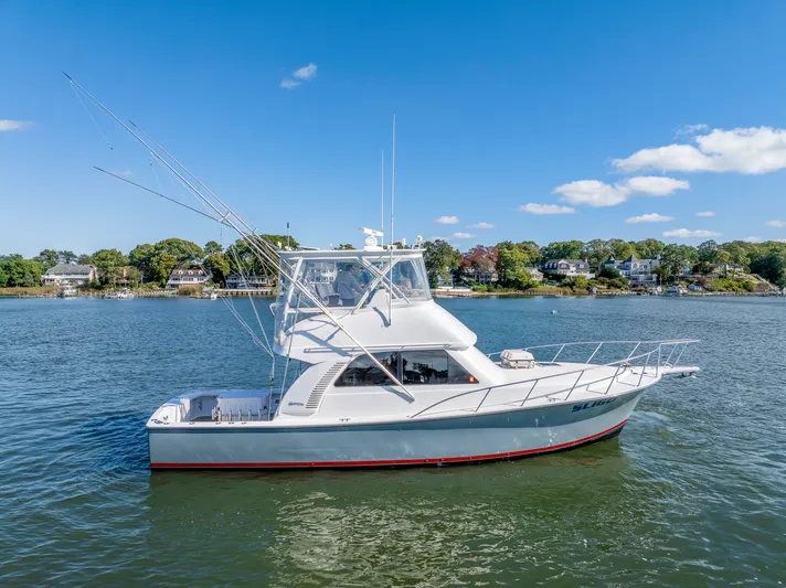 Sligo Yacht Photos Pics 2023 Henriques 42 Convertible yacht on calm water, clear sky background.