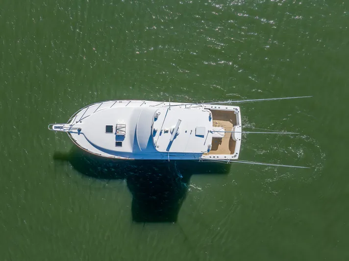 Sligo Yacht Photos Pics Aerial view of 2023 Henriques 42 Convertible yacht on green water.