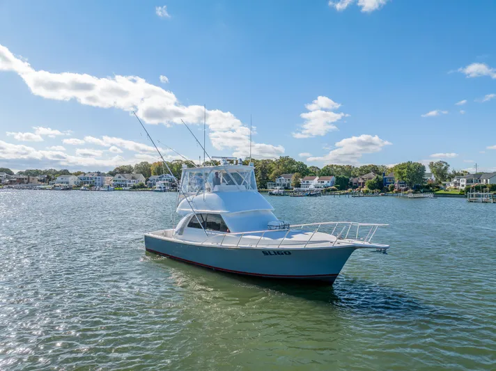 Sligo Yacht Photos Pics 2023 Henriques 42 Convertible yacht on calm water under a clear blue sky.