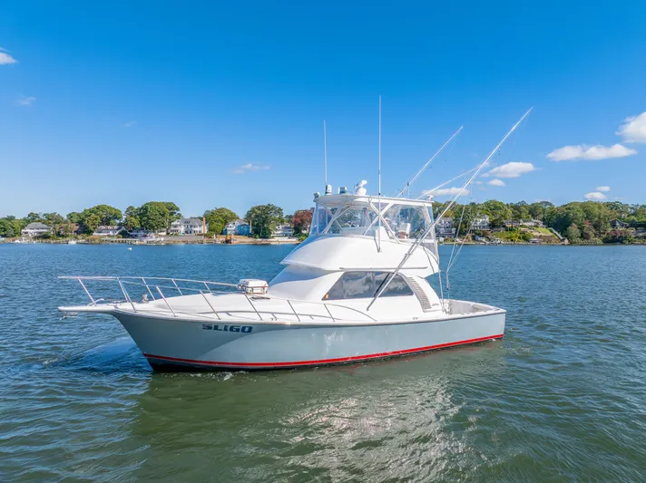 Sligo Yacht Photos Pics 2023 Henriques 42 Convertible yacht on calm water under clear blue sky.