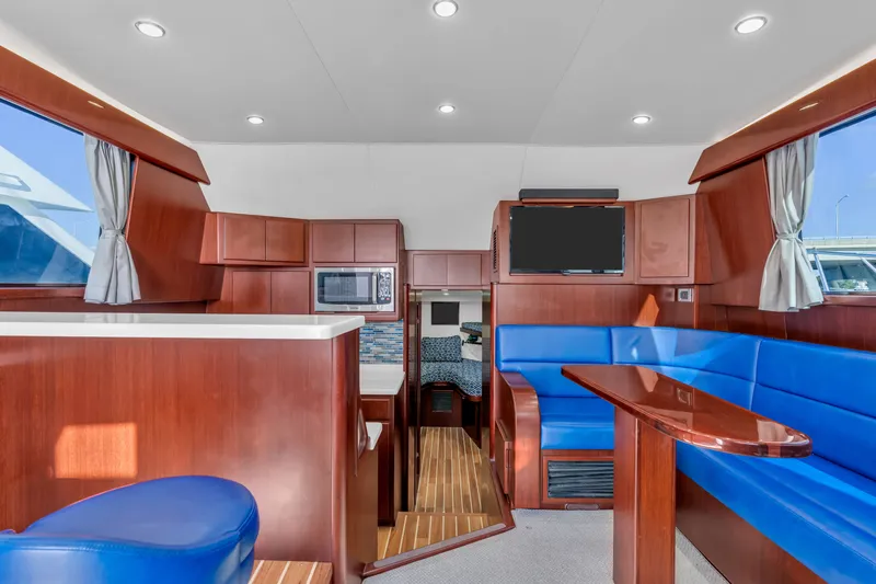 Sligo Yacht Photos Pics Interior of 2023 Henriques 42 Convertible yacht with modern wood and blue seating.