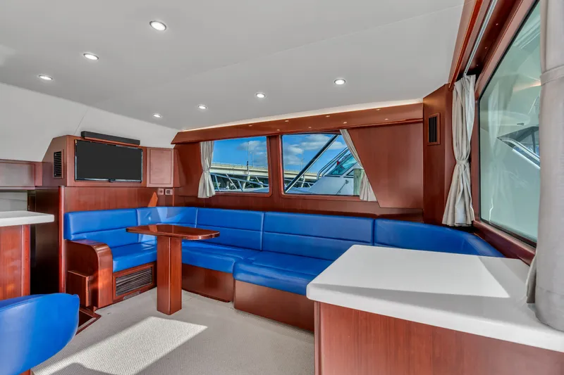 Sligo Yacht Photos Pics Luxurious interior of 2023 Henriques 42 Convertible yacht with blue seating and wood accents.