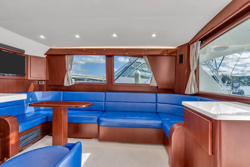 Sligo Yacht Photos Pics Luxurious interior of 2023 Henriques 42 Convertible yacht with blue seating and wood accents.