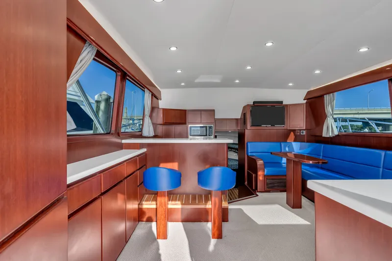 Sligo Yacht Photos Pics Luxurious interior of 2023 Henriques 42 Convertible yacht with modern furnishings and blue seating.