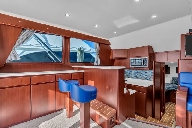 Sligo Yacht Photos Pics Luxurious interior of 2023 Henriques 42 Convertible yacht with modern kitchen and seating.