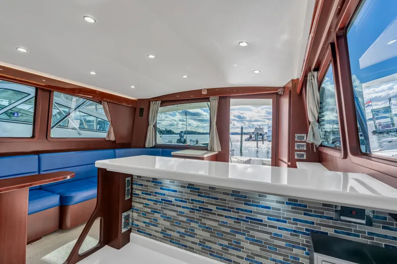 Sligo Yacht Photos Pics Interior of 2023 Henriques 42 Convertible yacht with modern seating and panoramic windows.