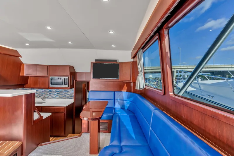Sligo Yacht Photos Pics Luxurious interior of 2023 Henriques 42 Convertible yacht with blue seating and modern kitchen.