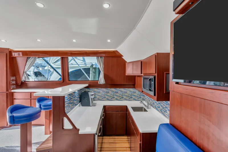 Sligo Yacht Photos Pics Luxurious interior of 2023 Henriques 42 Convertible yacht with modern kitchen and seating.