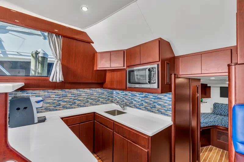 Sligo Yacht Photos Pics Luxurious 2023 Henriques 42 Convertible yacht kitchen with modern cabinetry and sleek design.