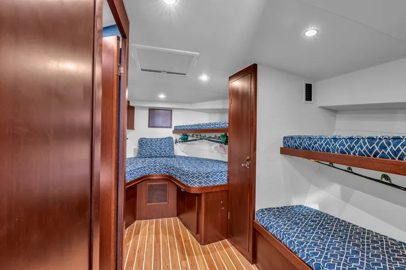 Sligo Yacht Photos Pics 2023 Henriques 42 Convertible yacht interior with wooden finish and blue patterned bedding.