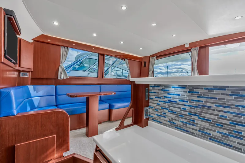 Sligo Yacht Photos Pics 2023 Henriques 42 Convertible yacht interior with blue seating and modern design.