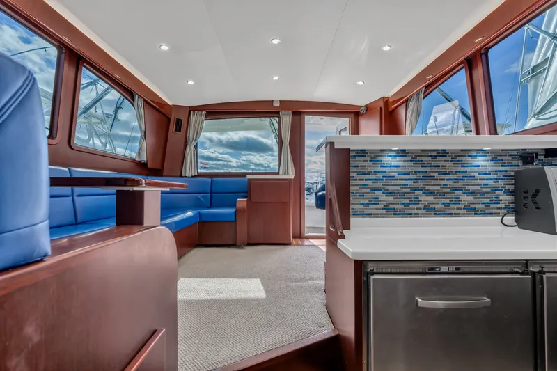 Sligo Yacht Photos Pics Interior of 2023 Henriques 42 Convertible yacht with modern seating and stylish kitchenette.