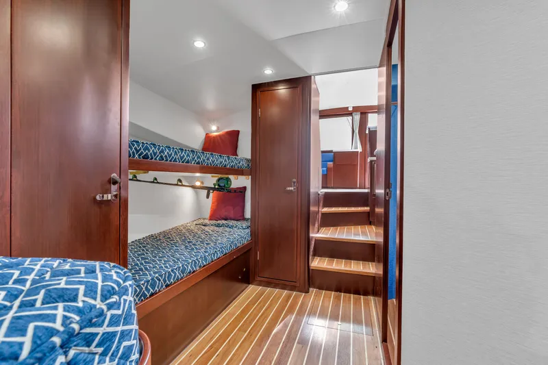 Sligo Yacht Photos Pics Interior of 2023 Henriques 42 Convertible yacht with bunk beds and wooden flooring.