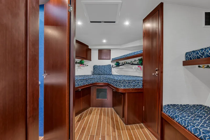 Sligo Yacht Photos Pics 2023 Henriques 42 Convertible cabin with wooden interior and blue patterned bedding.