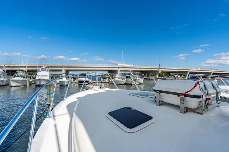 Sligo Yacht Photos Pics Henriques 42 Convertible yacht docked near a bridge under a clear blue sky, 2023 model.