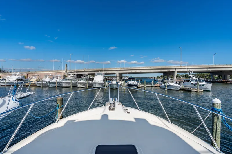 Sligo Yacht Photos Pics 2023 Henriques 42 Convertible yacht docked in a marina under a clear blue sky.