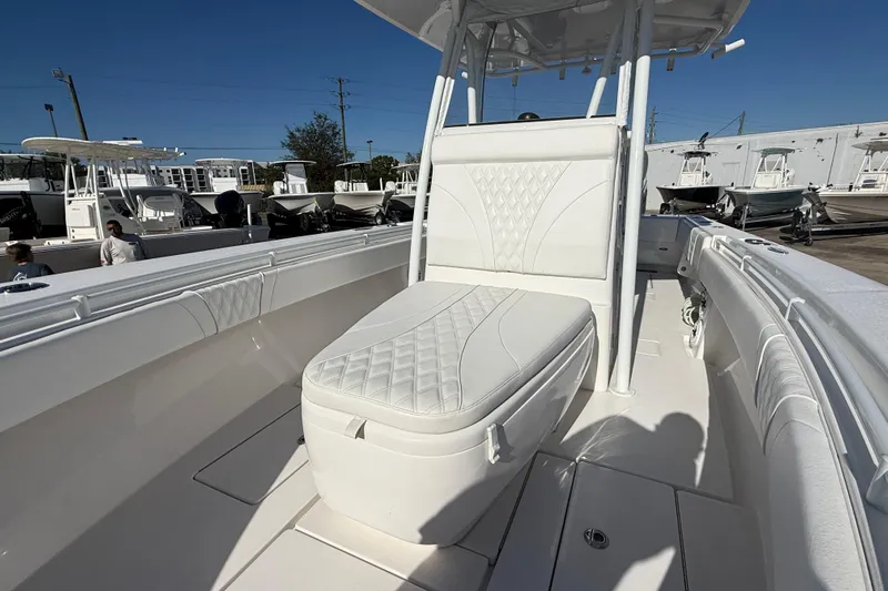  Yacht Photos Pics 2024 Contender 30 ST boat with white cushioned seating and sleek design.