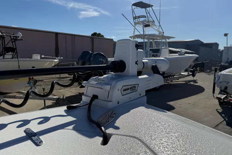  Yacht Photos Pics 2024 Contender 30 ST boat with Minn Kota trolling motor in a marina setting.