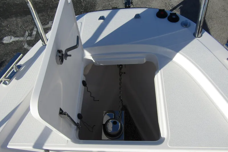  Yacht Photos Pics Open anchor compartment on 2025 Nimbus Tender 9 boat, showcasing storage and chain mechanism.