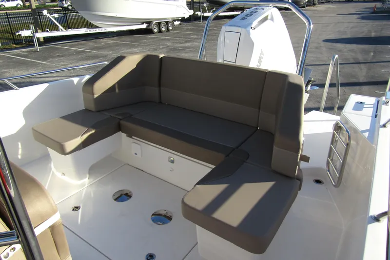  Yacht Photos Pics Spacious seating area on 2025 Nimbus Tender 9 boat, featuring comfortable cushions and modern design.