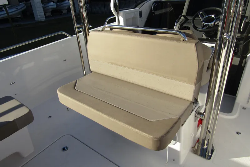  Yacht Photos Pics 2025 Nimbus Tender 9 boat interior with beige seating and steering wheel.