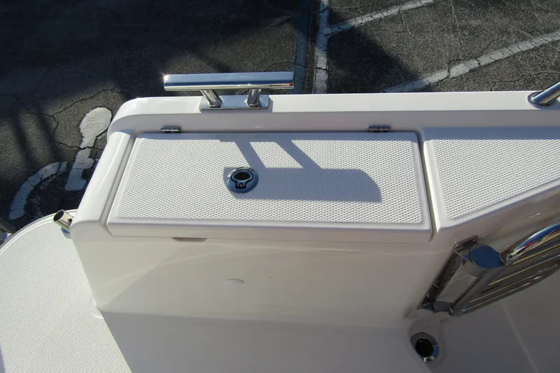  Yacht Photos Pics 2025 Nimbus Tender 9 boat deck with storage compartment and railing.